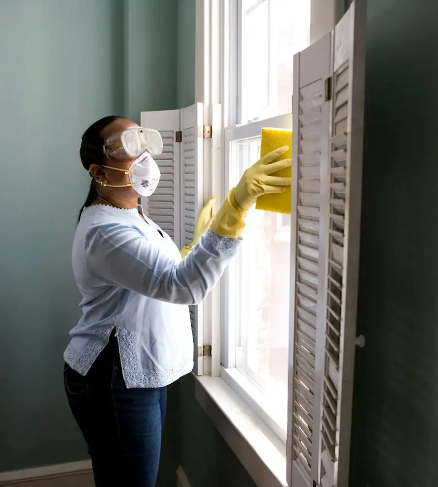 Maubell team member cleaning a window